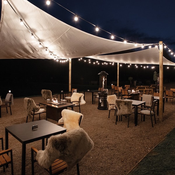 When the evening draws in, gather around the terrace fire pits to stay warm, sip a drink, and soak up good company.