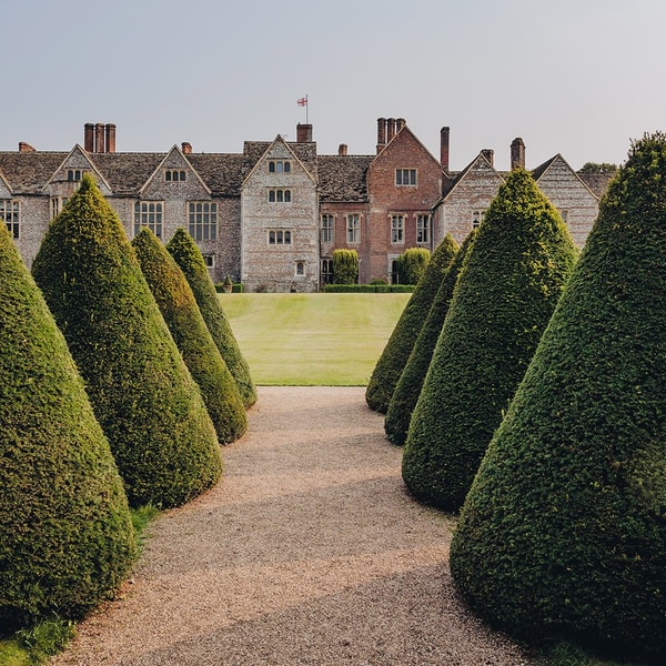 The gardens at Littlecote House are grand, with winding paths and sculpted shrubs that invite exploration.