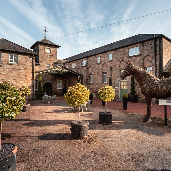 In the courtyard, a whimsical horse statue stands proudly among the shrubs - another unique little corner just waiting to be explored.