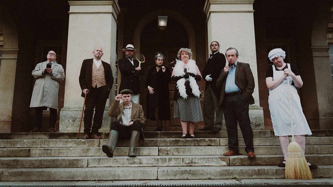 set of actors for the murder mystery break on stairs