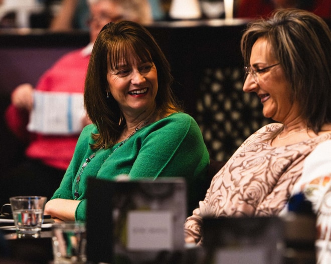 Two ladies laughing together