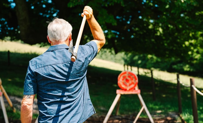 Man taking part in Axe throwing at Warner Hotels