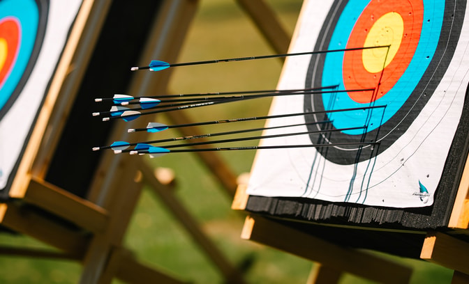 Close up view of two archery boards with arrows in