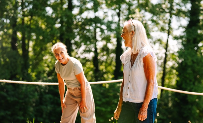 A couple of guests enjoying time together playing axe throwing