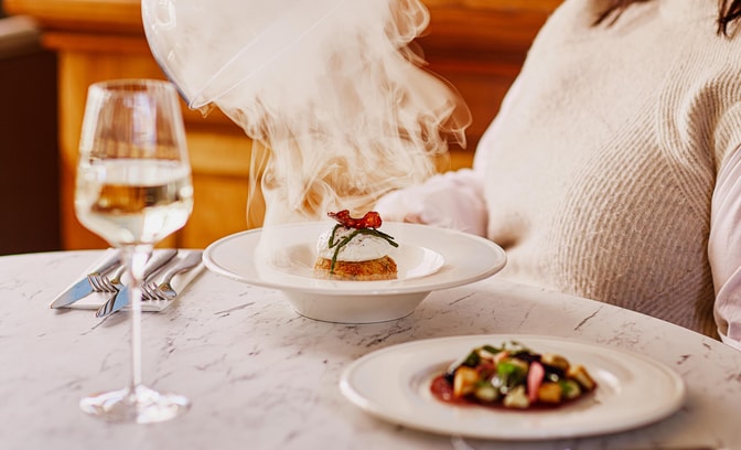 Close up of a steaming dish of smoked haddock fishcake