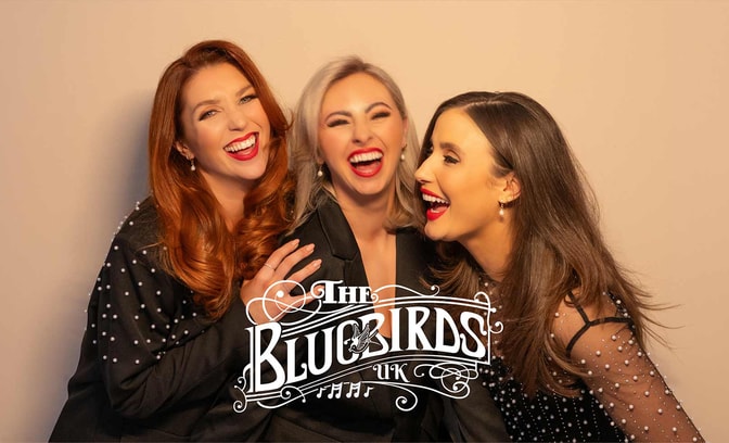 Bluebirds singing group in front of a beige background