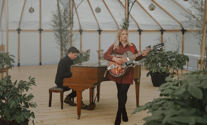 Dolly Mavies singing in greenhouse