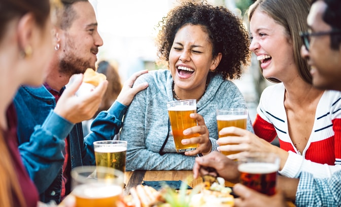 A group of friends eating and drinking at a food festival