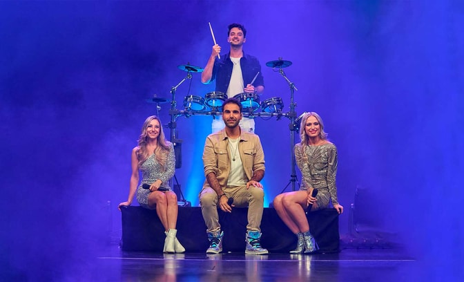 The band ODY.C sitting with their instruments