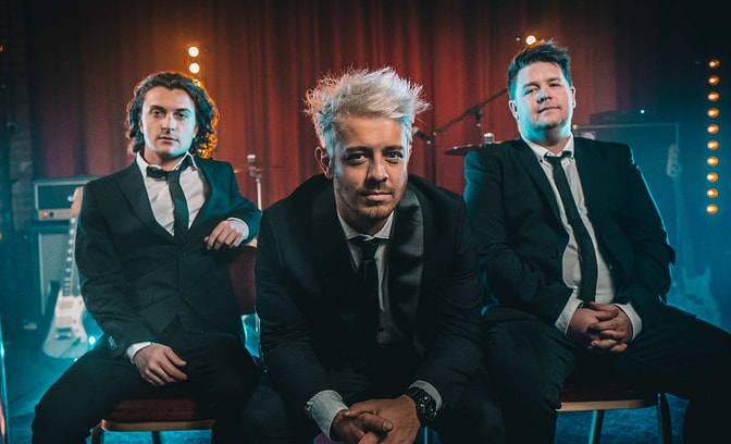 Atlantis band sitting together in suits