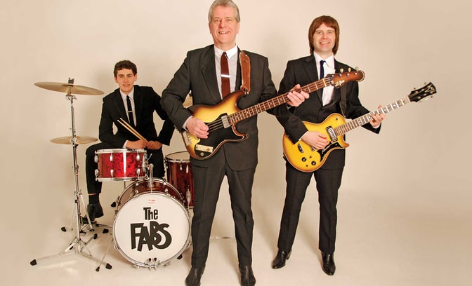 The Fabs, standing with their guitars