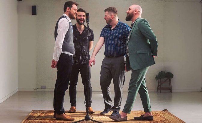 The four kicks in a white room with a mic