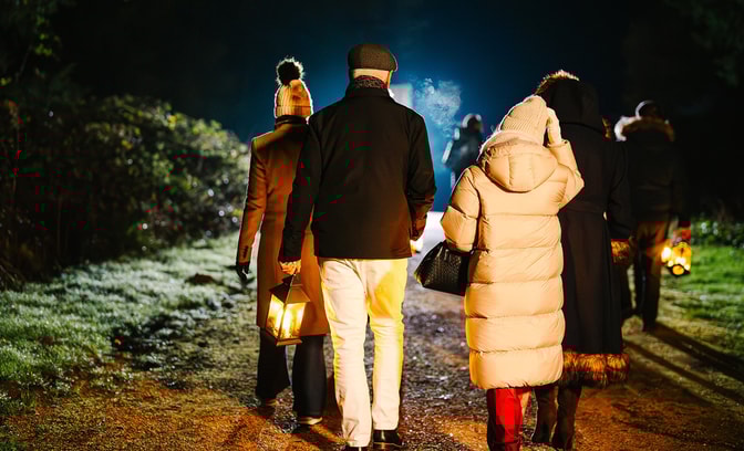 Guests wandering through the hotel grounds on a magical lantern lit walk