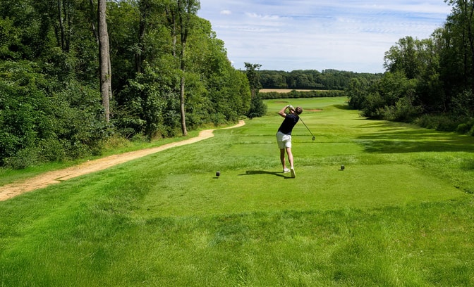 Person playing golf at Heythrop Park's championship golf course