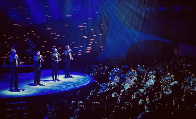 The West End Tenors performing on stage in front of a live audience