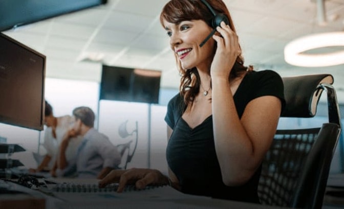 Office setting with a woman wearing a headset at Warner Contact Center.