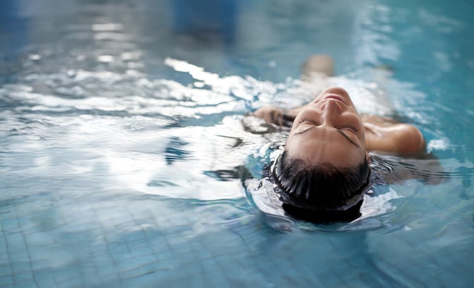 Lady swimming in a pool