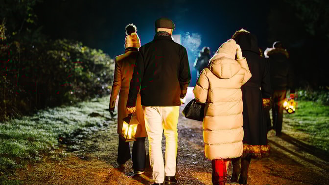 Guests wandering through the hotel grounds on a magical lantern lit walk