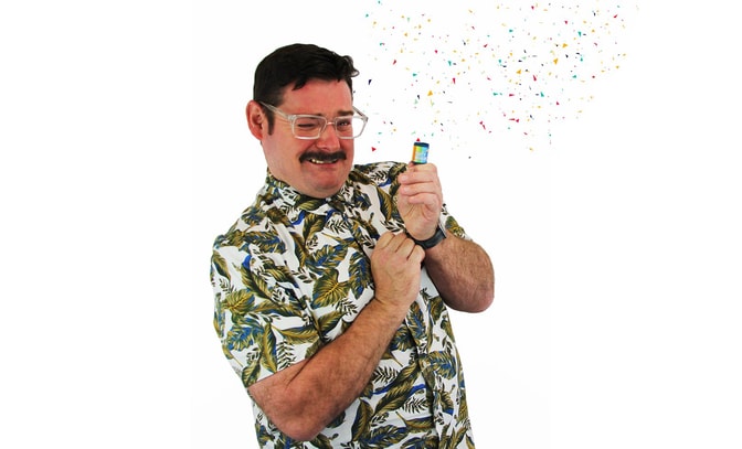 David Arnold pulling a party popper and colourful confetti appearing