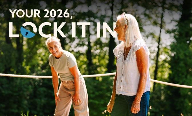 Two women engage in an outdoor activity, surrounded by greenery, with text overlay that says "YOUR 2026, LOCK IT IN."