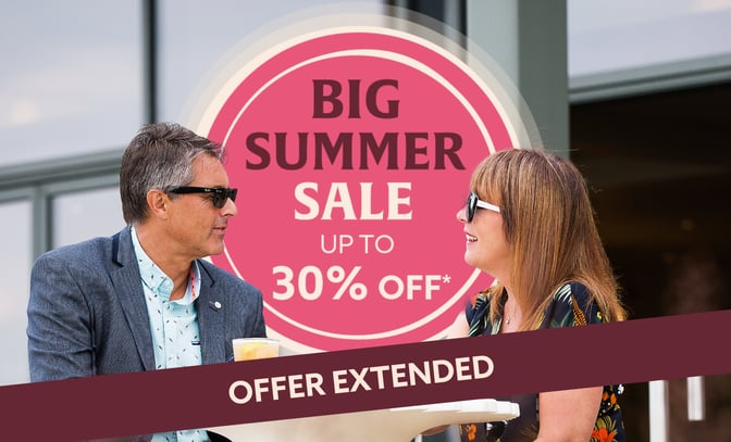 A couple enjoys drinks at Studley Castle, with a promotional banner for a big summer sale offering up to 30% off, stating "Offer Extended."