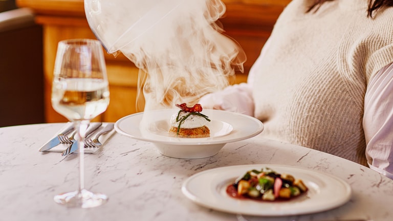Close up of a steaming dish of smoked haddock fishcake