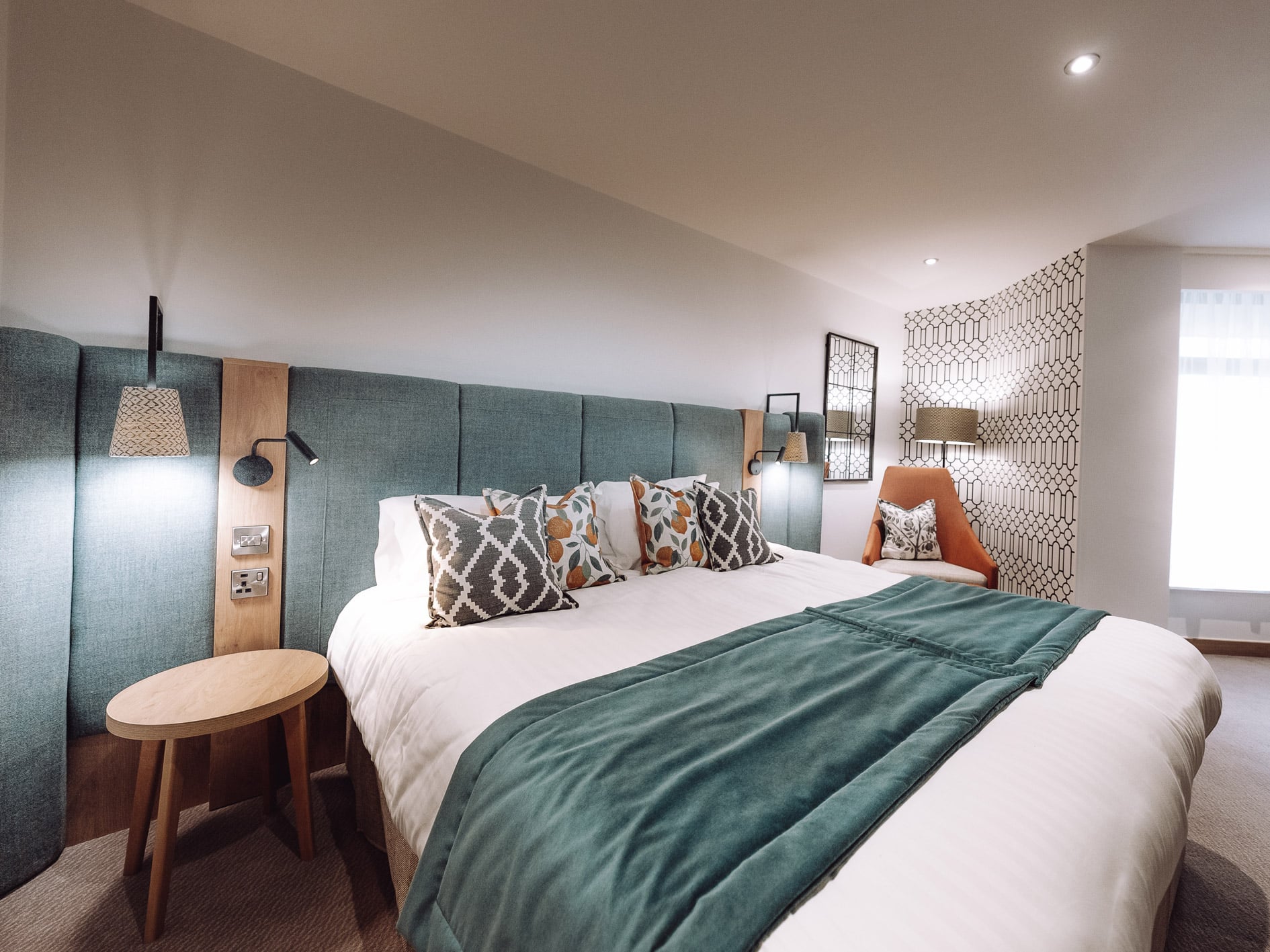 Close up of a large bed with relaxing lighting