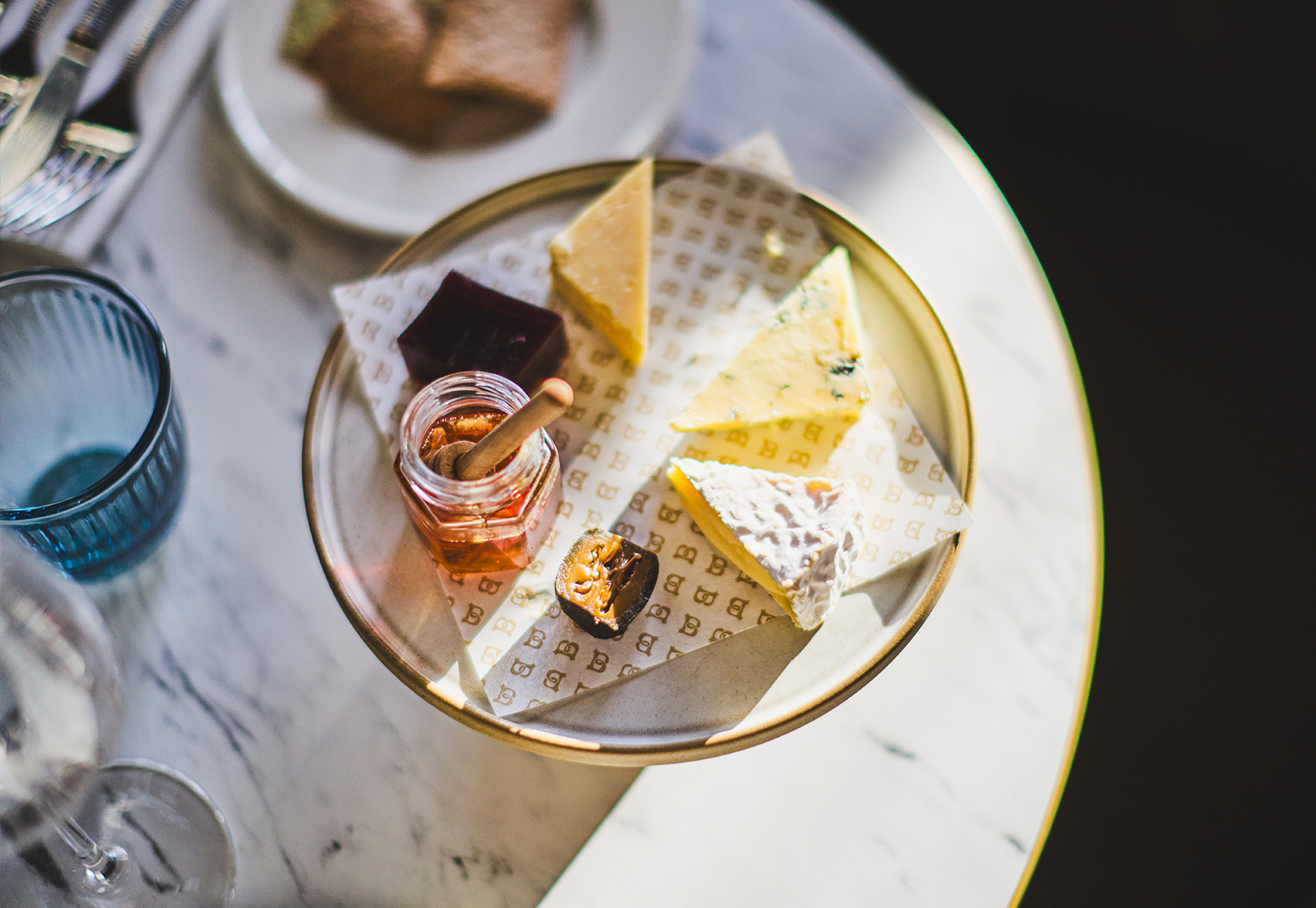 aerial view of a cheeseboard with honey and crackers