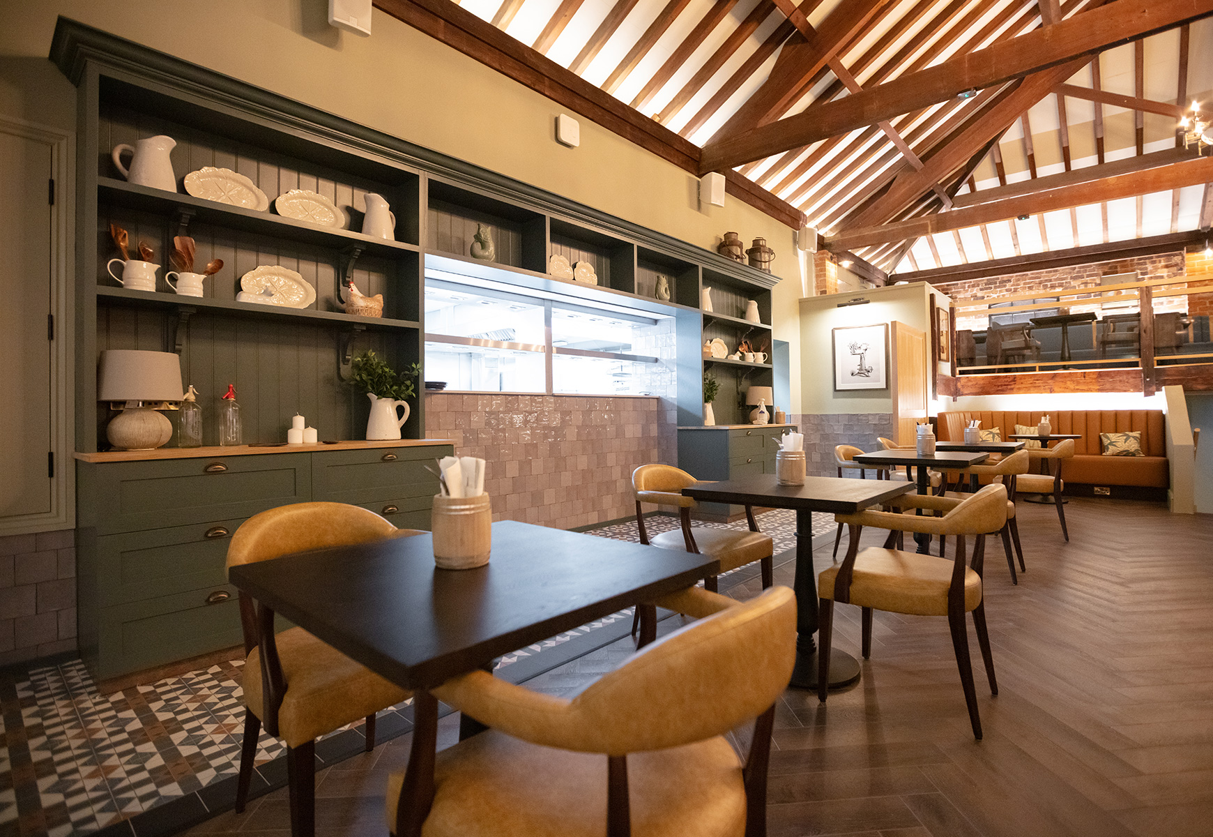 barn style restaurant with leather chairs and wooden tables