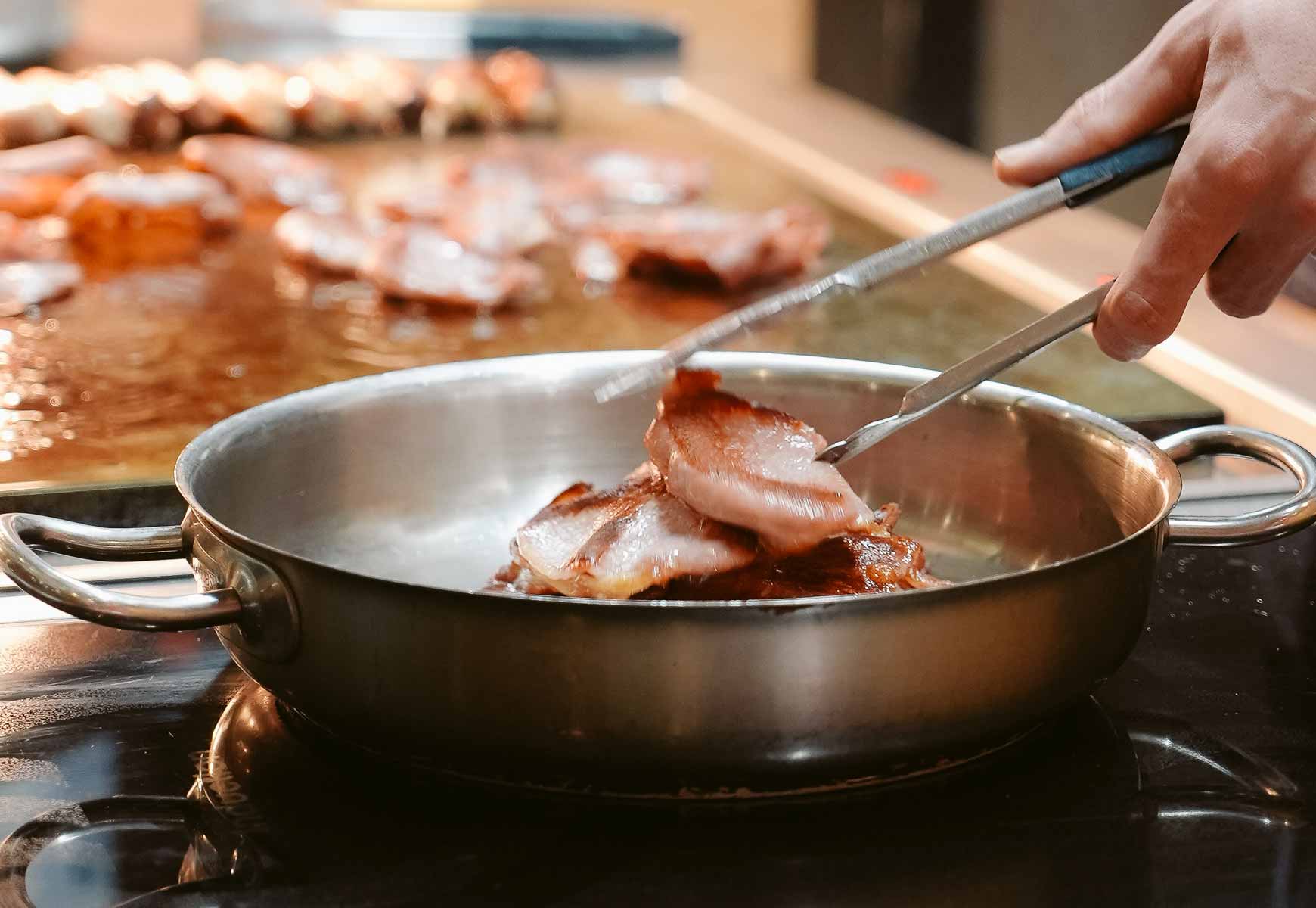 bacon frying in a pan