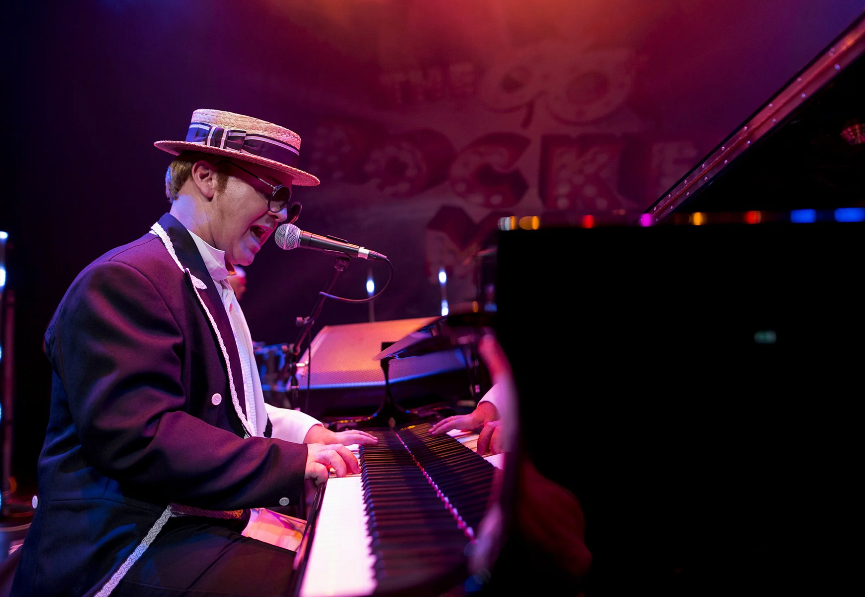 Jimmy Love as Elton performing on stage