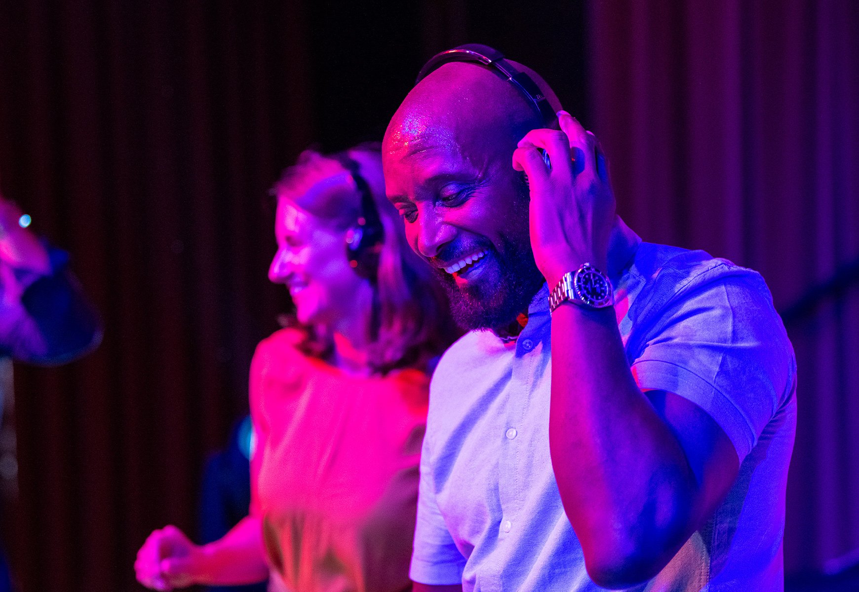 People dancing with headphones on during a silent disco