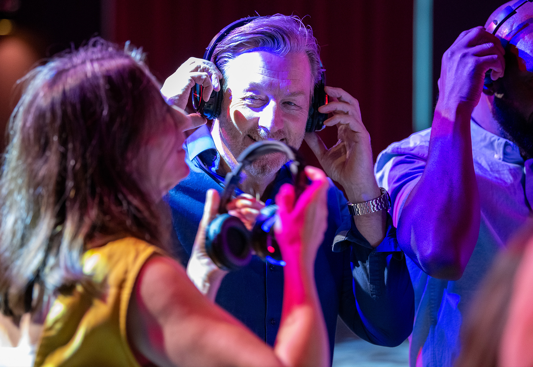 Guests smiling as they enjoy a silent disco